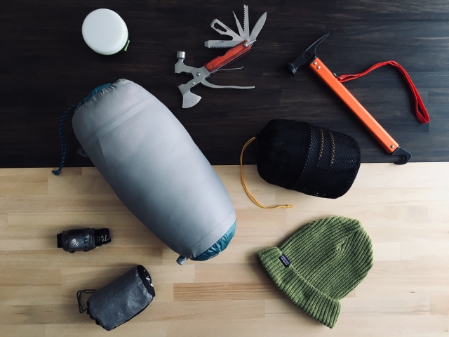 アウトドアギアを床において様々な道具が登山には必要という意味合いを表現。